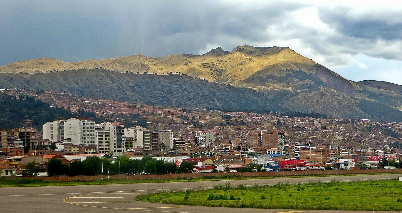 Aerial view of Cusco city and its mountain-ringed airport runway in the Andes